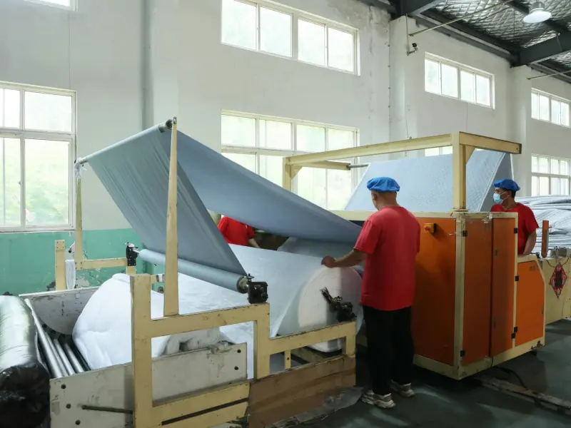 Raw fabric passing through a fabric inspection machine before production